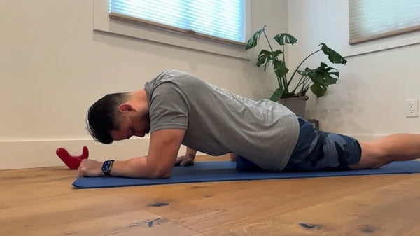 Person using a red Core Nexus on a floor mat