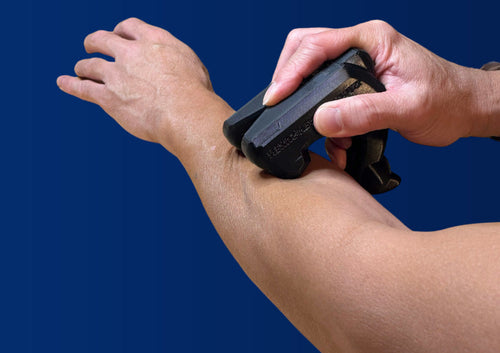 One hand holding the Black Swan forearm channel against the opposite forearm