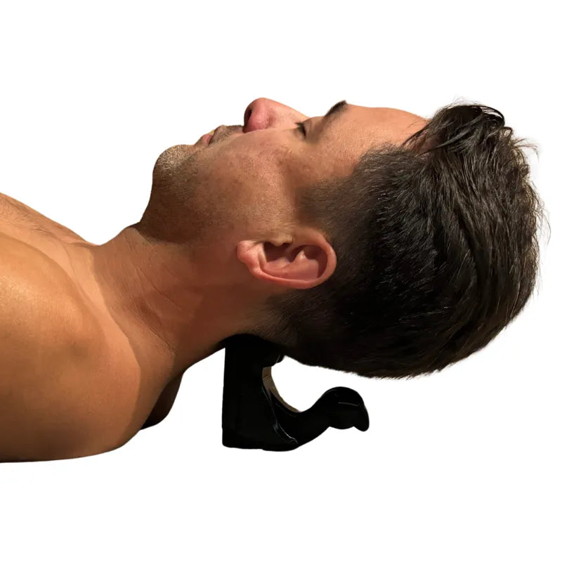 Black Swan suboccipital release tool in use — gravity-assisted pressure at the base of the skull for neck tension