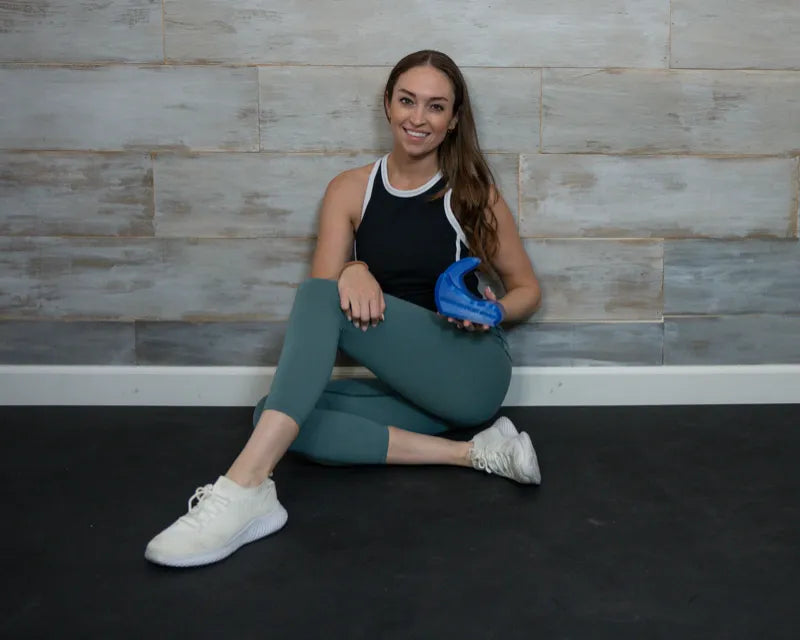 Dr. Steph Dorworth, physical therapist, seated with the Core Nexus psoas release tool